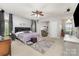 Spacious main bedroom with a ceiling fan, sitting area, and neutral carpet at 7525 Windy Pine Cir, Denver, NC 28037