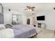 A bright main bedroom featuring a sitting area and a ceiling fan for added comfort at 7525 Windy Pine Cir, Denver, NC 28037