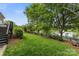 Scenic backyard with a manicured lawn, elegant fence, mature trees and a tranquil water view at 7811 Compton Ct, Charlotte, NC 28270