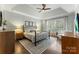 Bright bedroom with tray ceiling, large window, wood floors, and stylish furnishings at 7811 Compton Ct, Charlotte, NC 28270