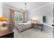 Cozy bedroom with a fluffy bed, a decorative chandelier and a modern desk at 7811 Compton Ct, Charlotte, NC 28270