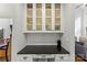 Charming butler pantry with glass cabinets, granite countertops, and white subway tile at 7811 Compton Ct, Charlotte, NC 28270