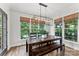 Bright dining room featuring a large table, modern lighting, and natural light at 7811 Compton Ct, Charlotte, NC 28270