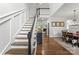 Elegant foyer with staircase, hardwood floors, and sophisticated decor leading to open living spaces at 7811 Compton Ct, Charlotte, NC 28270