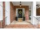 Inviting front porch with decorative wreath, potted plants, and cozy rocking chairs at 7811 Compton Ct, Charlotte, NC 28270