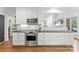 Well-lit kitchen featuring stainless steel appliances, white cabinetry and subway tile backsplash at 7811 Compton Ct, Charlotte, NC 28270