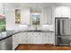 Modern kitchen featuring white cabinets, stainless steel appliances, and sleek countertops at 7811 Compton Ct, Charlotte, NC 28270