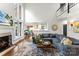Open concept living room with fireplace, large windows, and access to the kitchen at 7811 Compton Ct, Charlotte, NC 28270
