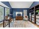 Comfortable home office with wood floors, built-in shelves, a work desk and a chair at 7811 Compton Ct, Charlotte, NC 28270