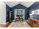 Stylish home office with bay window, built-in shelves, and rich navy blue walls at 7811 Compton Ct, Charlotte, NC 28270