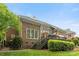 Back exterior of a two-story brick house with deck, steps, and manicured landscaping at 7811 Compton Ct, Charlotte, NC 28270
