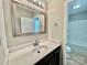Bathroom features large mirror, undermount sink, and tiled shower at 915 Klondale Ave, Kannapolis, NC 28081