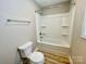 Bathroom features a shower and toilet with tile and wood look flooring at 915 Klondale Ave, Kannapolis, NC 28081