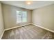 Bedroom featuring a window that brings in great natural light, neutral walls, and carpeted floors at 915 Klondale Ave, Kannapolis, NC 28081