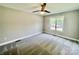 This bedroom has neutral walls, carpet, a ceiling fan, and a window at 915 Klondale Ave, Kannapolis, NC 28081