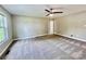 Neutral bedroom features a ceiling fan, carpet, and large window at 915 Klondale Ave, Kannapolis, NC 28081