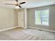 Bedroom features neutral walls, carpet, a ceiling fan, and a window at 915 Klondale Ave, Kannapolis, NC 28081