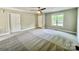 Neutral bedroom features carpet, ceiling fan, and window letting in natural light at 915 Klondale Ave, Kannapolis, NC 28081