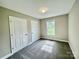 Bright bedroom with neutral walls, carpet, two closets, and natural light from the window at 915 Klondale Ave, Kannapolis, NC 28081