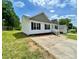 Home featuring white siding and a well-maintained lawn in a desirable neighborhood at 915 Klondale Ave, Kannapolis, NC 28081