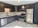 Kitchen features stainless steel appliances, dark wood cabinets, and light countertops at 915 Klondale Ave, Kannapolis, NC 28081