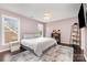 Comfortable bedroom featuring neutral tones, a ceiling fan, and a bright window for natural light at 10202 Alouette Dr, Waxhaw, NC 28173