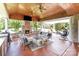 Relaxing covered patio with fireplace, outdoor seating, ceiling fans and a built in grill at 10202 Alouette Dr, Waxhaw, NC 28173