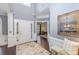 Elegant foyer features high ceilings, dark hardwood floors, wainscoting and a view into the office at 10202 Alouette Dr, Waxhaw, NC 28173