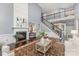 Open living room featuring a fireplace, hardwood floors, staircase with iron railing and lots of natural light at 10202 Alouette Dr, Waxhaw, NC 28173
