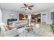 Open-concept living room with kitchen in the background, comfortable seating, and tile flooring at 10202 Alouette Dr, Waxhaw, NC 28173