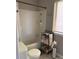 Neat bathroom features a shower-tub combo, toilet, and storage shelves with towels at 11106 Harrowfield Rd, Charlotte, NC 28226