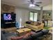 Open living room showcasing a brick accent wall and seamless connection to the dining area at 11106 Harrowfield Rd, Charlotte, NC 28226