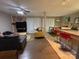 Open living room featuring a brick accent wall, comfortable seating, and a seamless transition to the dining area at 11106 Harrowfield Rd, Charlotte, NC 28226