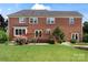 Backyard features a well-maintained lawn, a wooden deck, and mature landscaping for privacy at 11917 Chevis Ct, Charlotte, NC 28277