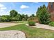 Spacious backyard with lush lawn, mature trees, decorative stones, and a charming wooden gazebo at 11917 Chevis Ct, Charlotte, NC 28277