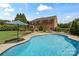 The in-ground pool and lush yard create the perfect backdrop for outdoor entertaining and relaxation at 11917 Chevis Ct, Charlotte, NC 28277