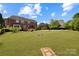 Expansive backyard featuring a patio, pool, lush lawn, and privacy landscaping at 11917 Chevis Ct, Charlotte, NC 28277