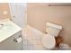 Compact bathroom featuring a toilet, vanity, and tiled floor offering functionality at 11917 Chevis Ct, Charlotte, NC 28277