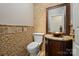 Elegant powder room featuring stone mosaic wall tiles, granite countertops, and copper sink at 11917 Chevis Ct, Charlotte, NC 28277