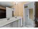 The bright bathroom has a double sink vanity and a shower with a curtain at 11917 Chevis Ct, Charlotte, NC 28277