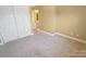 Bedroom featuring neutral carpet, a closet, and a connecting door to the bathroom at 11917 Chevis Ct, Charlotte, NC 28277