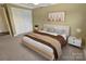 Cozy bedroom featuring neutral tones and a stylish modern bed frame with soft textures at 11917 Chevis Ct, Charlotte, NC 28277
