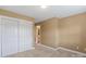 This bedroom has an adjacent bathroom and closet with bi-fold doors at 11917 Chevis Ct, Charlotte, NC 28277