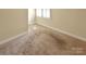 Bedroom with neutral colored walls and carpet, offers a calming and adaptable living space at 11917 Chevis Ct, Charlotte, NC 28277