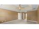 Large bedroom featuring neutral carpet, tray ceilings, and views of a possible bathroom and walk in closet at 11917 Chevis Ct, Charlotte, NC 28277