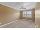 This spacious bedroom has neutral carpeting and window with white shutters at 11917 Chevis Ct, Charlotte, NC 28277