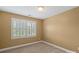 This cozy bedroom features neutral carpeting and a window with white shutters at 11917 Chevis Ct, Charlotte, NC 28277