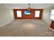 Spacious bonus room with neutral walls, a TV, and plenty of space for customization at 11917 Chevis Ct, Charlotte, NC 28277
