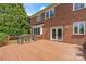 A wooden deck with patio seating overlooks the lush yard with beautiful trees at 11917 Chevis Ct, Charlotte, NC 28277