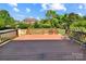 Spacious wooden deck overlooking the backyard with green grass and lush foliage at 11917 Chevis Ct, Charlotte, NC 28277